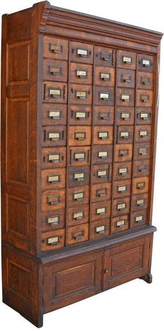 an old wooden filing cabinet with many drawers