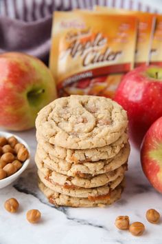 cookies, nuts and apples on a marble countertop with cereals in the background