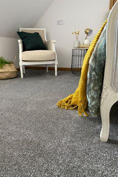 a bedroom with gray carpet and white furniture