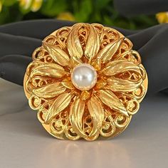 Vintage Signed Lieba Gold Filigree Pearl Flower Scarf Shawl Clip  Signed Lieba (inside clip) filigree flower scarf shawl clip with single faux pearl accent. Clip mechanism in good working condition.  Measures 1 1/2 inches tall and 1 1/2 inches wide.  In excellent vintage condition.  ATTENTION Jewelry Lover Save 15%Today!  Copy and Paste the Link: https://mailchi.mp/6c4f021a85cf/yesterdaysluster To sign up for our email list and receive a code to save 15% on your order. Our Mission: Our mission i Elegant Gold Brooches For Spring, Flower Scarf, Use Of Plastic, Heart Brooch, Shawl Pins, Vintage Clip, Beaded Choker Necklace, Pearl Flower, Gold Filigree