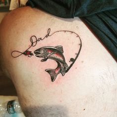 a man with a tattoo on his stomach holding a fishing rod in the shape of a heart