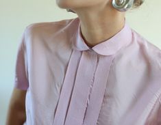 Vintage pink silk short sleeve button up shirt blouse top. Hidden front buttons, unusual rounded collar, no lining. Material feels like silk acetate blend. Size 40 on tag. Fits like size S-M. Measured laying flat, double for circumference: 21" / 54 cm long 19.5" / 50 cm armpit to armpit 17.5" / 45 cm waist There is a small spot near hem, please see the last pic, otherwise very good vintage condition. Pink Short Sleeve Blouse For Work, Feminine Short Sleeve Shirt With Buttons, Vintage Pink Blouse For Formal Occasions, Pink Silk Shirt For Spring, Pink Short Sleeve Blouse For Formal Occasions, Silk Short Sleeve Shirt For Formal Occasions, Pink Blouse With Placket For Spring, Chic Pink Blouse With Buttons, Elegant Short Sleeve Shirt With Placket