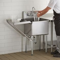 a man is washing his hands in the sink