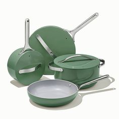 an assortment of green pots and pans on a white background with one empty pan