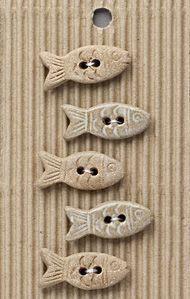 four fish are sitting on top of a piece of cardboard with holes in the middle