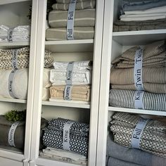 towels and blankets are stacked on shelves in the closet