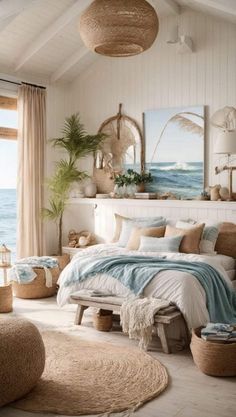 a bedroom with white walls and wooden flooring next to an ocean front window filled with plants