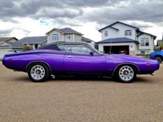 a purple car parked in front of a house