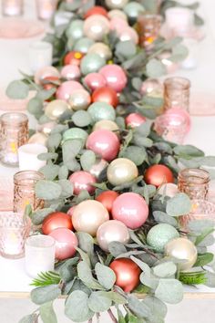 a long table with pink and green ornaments on it