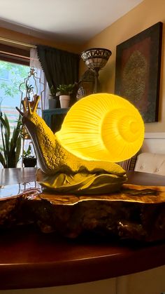 a yellow lamp sitting on top of a wooden table