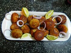 some food is sitting on a tray with onions and limes