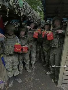 some soldiers are holding boxes with food in them