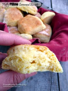 a person holding a half eaten biscuit in their hand