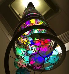 a multicolored stained glass lamp hanging from the ceiling