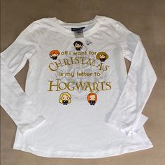 a white t - shirt that says all i want for christmas is my letter to hogwarts