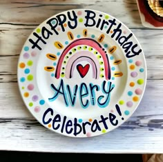 a birthday plate with the words happy birthday avery celebrate on it and a rainbow design