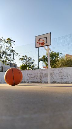 an orange basketball sitting on top of a basketball court