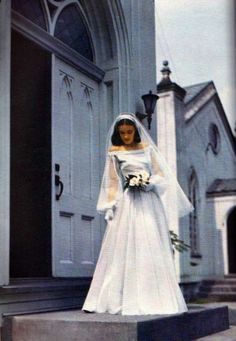 a woman in a wedding dress standing on steps