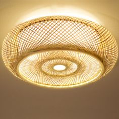 a light that is hanging from the ceiling with wickers on it's sides