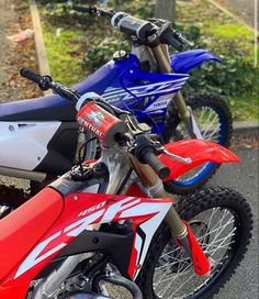 two dirt bikes parked next to each other