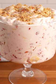 a dessert in a glass dish on top of a wooden table