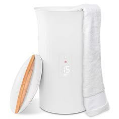 a white and wooden object next to a towel