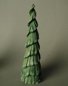 a green ceramic christmas tree on a table