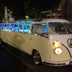 an old vw bus is parked on the side of the road at night time