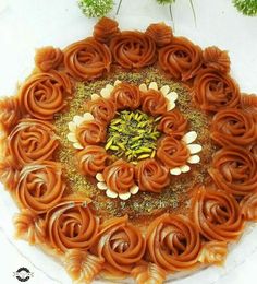 a cake decorated with flowers and nuts on a plate