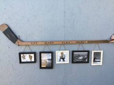 a hockey stick hanging from the side of a wall with pictures on it and an inscription that reads eat sleep play hockey