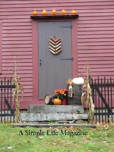 a simple life magazine cover with pumpkins on the front door and fall decorations outside