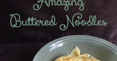 a white bowl filled with food on top of a purple table cloth and green lettering that reads amazing buttered noodles