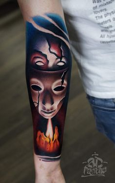 a man with a mask on his face and fire coming out of his mouth tattoo