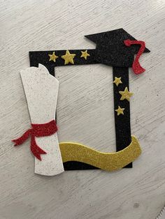 this is an image of a paper cut out of the letter j with stars and ribbon