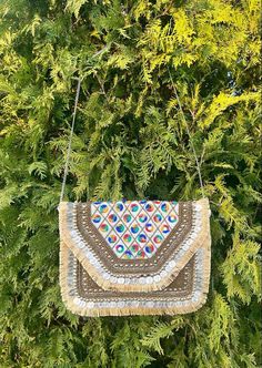 This is a beautiful handcrafted bohemian bag made with love. Get your boho vibe on with this chic and stylish bag. This Indian boho bag comes with intricate work and is the perfect festival bag. With its elegant and understated simplicity, this boho bag is eco friendly.  Decorated by hand, this boho bag is perfect for music festivals, vacations, or any adventure. Get your boho vibe on with this chic and stylish bag. Perfect as a handmade sustainable gift! Style tip : Throw in a pair of jeans with a summery top. The bag is so versatile that it goes with any outfit! IF THIS IS A GIFT, WE HAPPY TO ADD A HAND WRITTEN MESSAGE ON A CARD. PLEASE LEAVE A NOTE OR MESSAGE US. Dimensions - 30*23.5 CM Bohemian Clutch, Embroidered Purse, Bohemian Bag, Shell Bag, Bohemian Bags, Purse Vintage, Festival Bag, Dark Mark, Sustainable Gifts