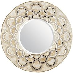 a white and gold plate with a circular mirror on it