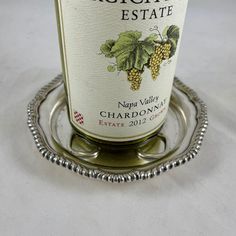 a bottle of wine sitting on top of a silver tray