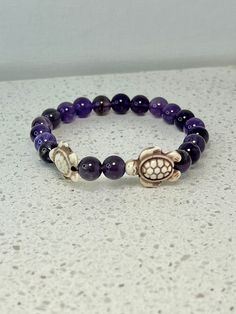 This gorgeous Turtle Bracelet is handmade with love and devotion, using Reconstituted Sea Turtles (8x14mm) and Amethyst 8mm round beads. I offer to resize bracelet, please let me know your wrist size. I will be happy to make it for you.Your 100% satisfaction is my goal. Color may vary slightly due to your monitors' color calibration settings.Each piece of Jewelry is unique and specially made for you or a loved one.Each piece of Jewelry is unique and specially made for you or a loved one.Material Adjustable Amethyst Stretch Bracelet With Round Beads, Adjustable Amethyst Stretch Bracelet, Adjustable Spiritual Purple Stretch Bracelet, Adjustable Amethyst Stretch Bracelet In Purple, Adjustable Purple Amethyst Stretch Bracelet, Adjustable Purple Stretch Bracelet With Natural Stones, Adjustable Purple Hand-strung Stretch Bracelet, Adjustable Purple Round Stretch Bracelet, Adjustable Hand-strung Purple Stretch Bracelet