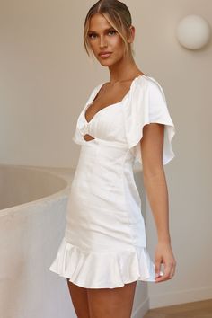 White satin dress  Lined  Pleated detail in bust  Angel sleeves with elasticated shoulders  Wide, ruffle hem  Zipper in back   All eyes will be on you in this pretty little number. Perfect for the modern bride or a special birthday celebration. We are obsessed with the pleated detail in the bust and its wide, ruffle hem so you can twirl the night away. Team it with a chic clutch and heels for an unforgettable look. White Satin Dress, Angel Sleeves, The Modern Bride, Angel Sleeve, Clothing Tags, Ruffle Hem Dress, Special Birthday, Modern Bride, Satin Dress