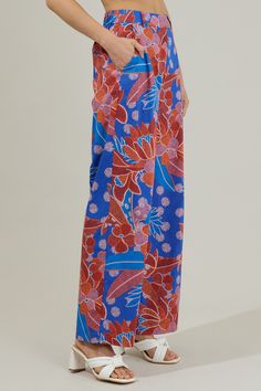 The Amazonia Blue Floral Mulvane Wide Leg Pants are here to show you keep you relaxed and in style! It shapes a high waist with a hidden zip fly and top button closure. It also has a stretchy waist on the back and pockets on each side. Pair this up with the matching top to complete the look!- Side pockets- High waist- Wide leg- Hook and clasp- Color: Blue RedSize + Fit - Model is 5'8" and wearing size XS- Measurements taken from size S - Waist: 14"- Inseam: 30 1/2" Fabric Self:100%Cotton Style N Versatile Blue Wide Leg Pants With Pockets, Loosely Fitted Versatile Blue Bottoms, Versatile Loosely Fitted Blue Bottoms, Versatile Blue Relaxed Fit Wide Leg Pants, Blue Beach Pants For Spring, Versatile Blue Wide Leg Pants, Versatile Blue Pants With Pockets, Blue Loungewear Pants With Elastic Waistband, Blue Straight Leg Loungewear Bottoms