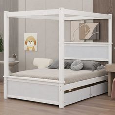 a white bed sitting in a bedroom on top of a hard wood floor next to a wooden table