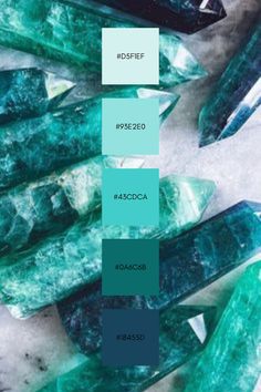 some green and blue colored rocks on a white surface with text overlaying them