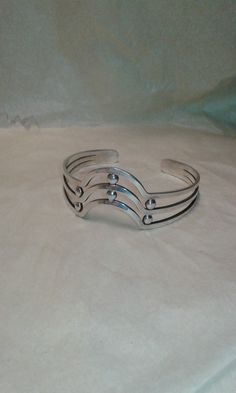 "Here is a handmade Egyptian silver bangle. This piece is unisex with a lovely wavy design with little \"spacers\" between the waves. The bangle weighs 35 grams of solid silver. This piece has silver marks and you can see them in the last photo." Adjustable Sterling Silver Unique Bangle, Adjustable Wavy Sterling Silver Jewelry, Handmade Silver Wavy Jewelry, Unique Sterling Silver Bracelet With Silver Beads, Wavy Design, The Bangles, Silver Candlesticks, Asian Jewelry, Vintage Bangles