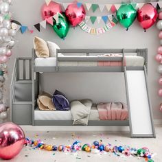 a bunk bed with balloons and streamers in the background