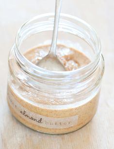 a spoon in a jar filled with peanut butter