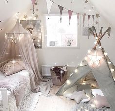 a bedroom with a teepee tent and lights