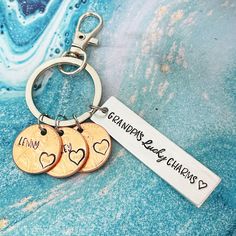 three personalized key chains with two hearts on them