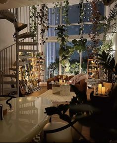 a living room filled with lots of furniture next to a spiral stair case in front of a window