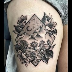 a woman's thigh with an image of mountains, trees and flowers on it