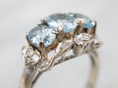 Treat yourself to something special with this dazzling ring! Show off your unique style with the glimmering white gold and aquamarine stones, sparkled with diamond accents. The perfect statement piece to let everyone know you mean business.Metal: 10K White GoldGem: 3 Aquamarine totaling 1.36 CaratsGem Measurements: 4.7 x 6.2 mm, OvalAccents: 16 Single Cut Diamonds totaling .22 Carats, SI in Clarity, G-H in ColorRing Size: 6.25Marks: "10K" Stamped on the inside band White Gold Aquamarine Ring, Gold Aquamarine Ring, Ring With Diamond, Aquamarine Ring, Aquamarine Stone, Aquamarine Rings, Watch Chain, Pearl Pendant, Charm Earrings